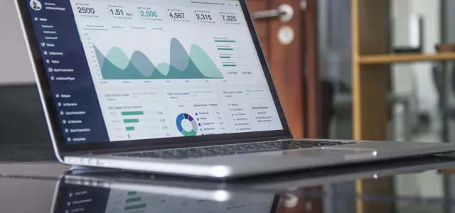 laptop computer on glass-top table by Carlos Muza courtesy of Unsplash.